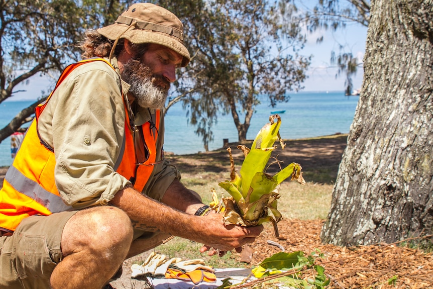 William Smart teaches the young adults about pest management and how to remove non-native vegetation.