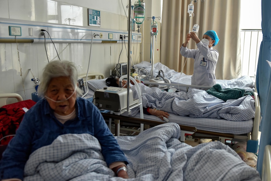 Elderly patients with COVID symptoms receive intravenous drips at the emergency ward.