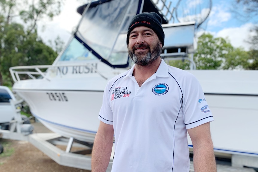 David Gould in front of his boat