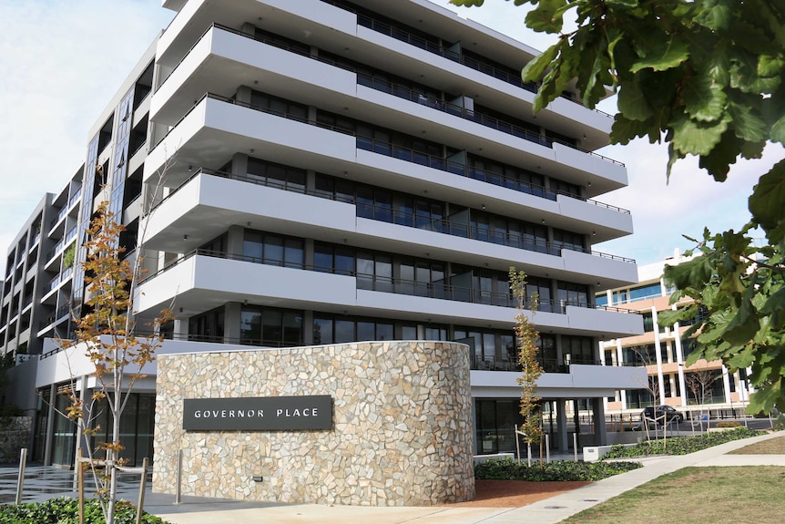 A modern apartment building in Canberra with a sign reading Governor Place.
