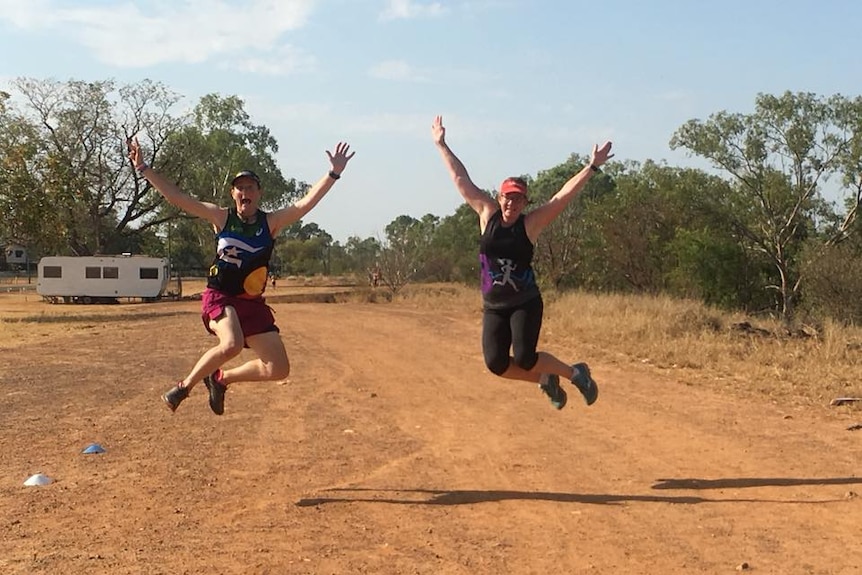 Two women leap into the air