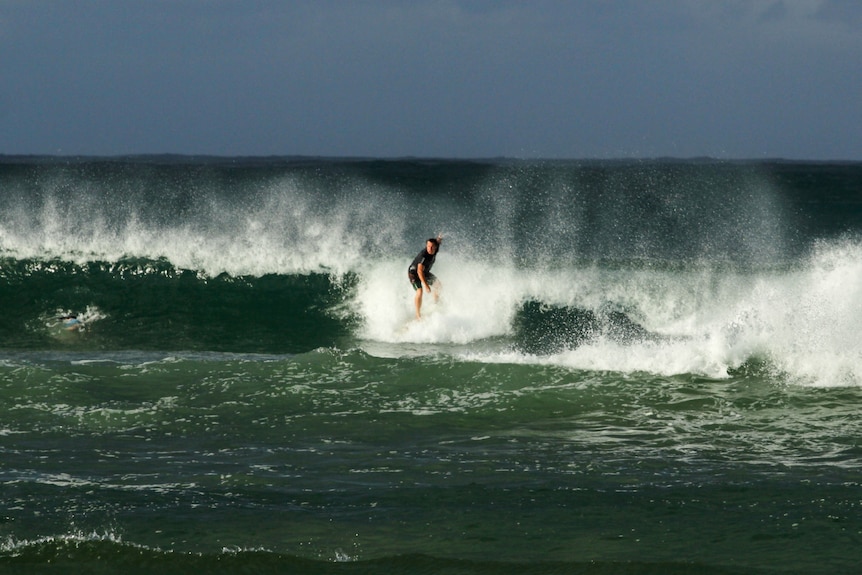 A surfer on a breaking wave. 