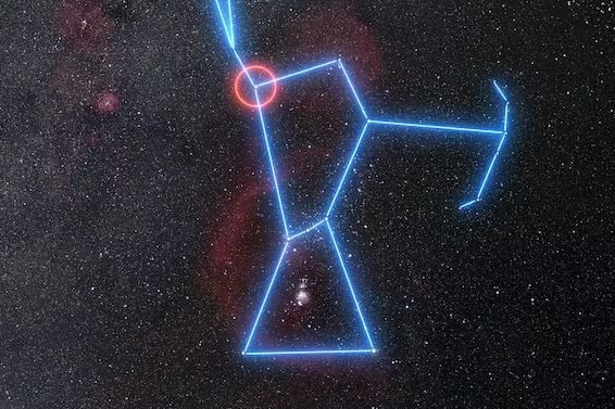 The night sky with blue lines overlaid showing the outline of Orion with Betelgeuse circled on the shoulder