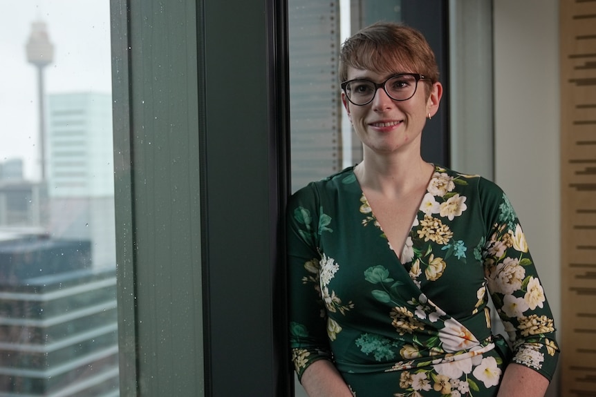 KPMG senior economist Sarah Hunter in an office with Centrepoint Tower visible outside the window.