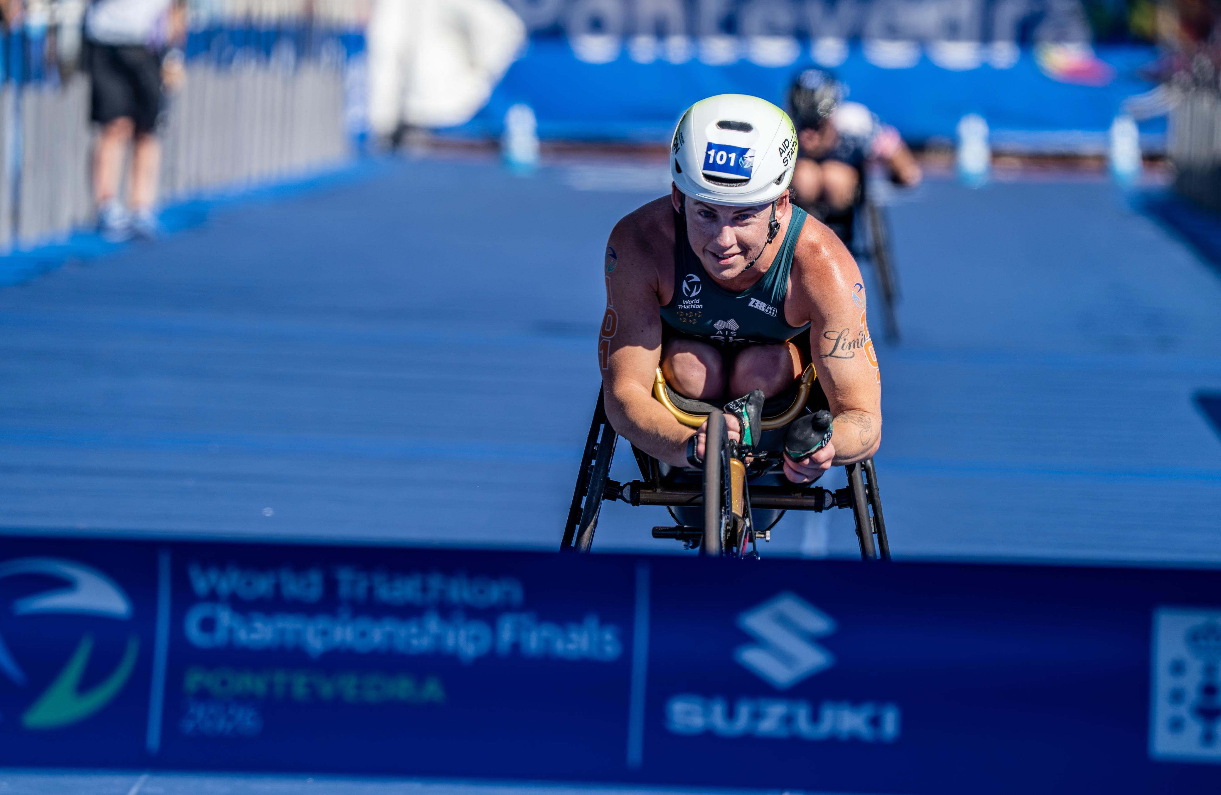 Lauren Parker races towards the line in a wheelchair.