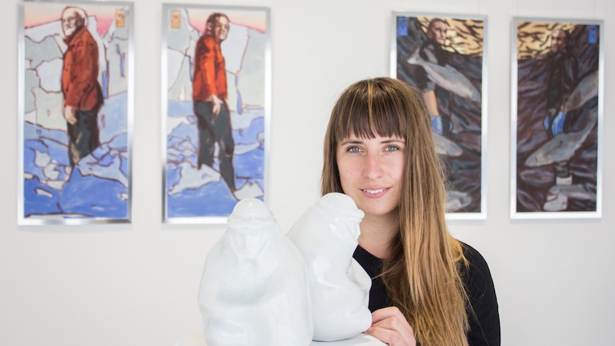 Artist Marion Abraham with her porcelain ceramics of an explorer crouching