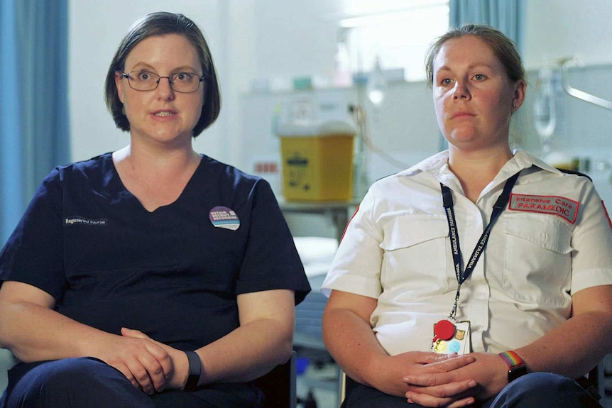 Ellen Anderson and Lauren Hepher sit next to each other in a hospital.