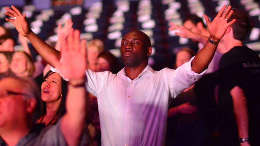 A member of Brisbane's Metro Church prays during a service.