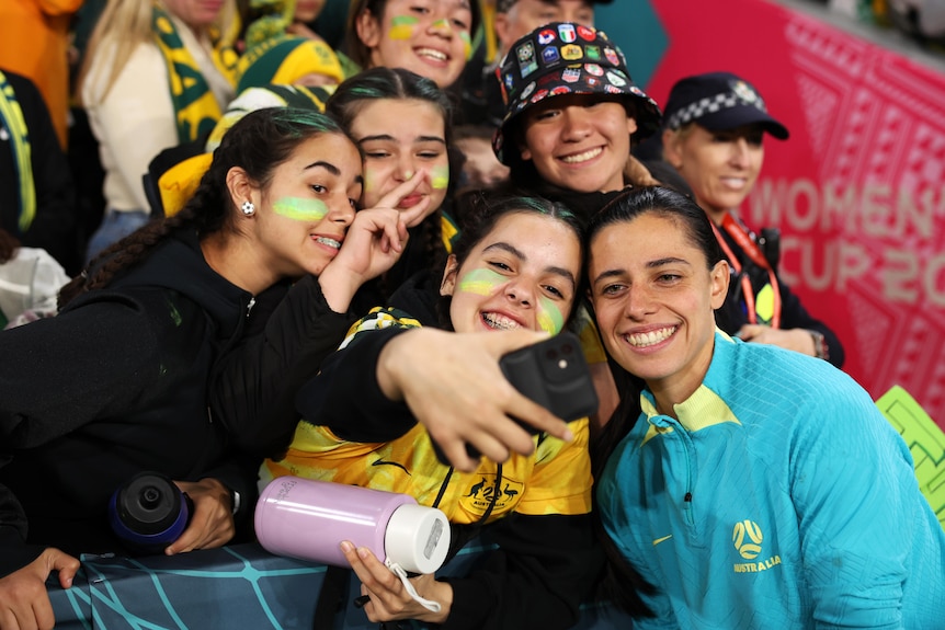 Matildas' Alex Chidiac poses for a selfie with fans at the FIFA Women's World Cup.