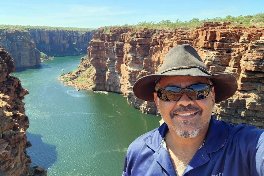 A man stands near King George Falls.