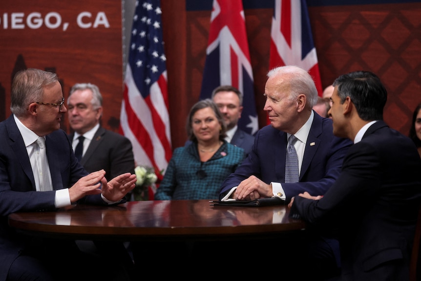 Anthony Albanese, Joe Biden and Rishi Sunak sit at a table at a San Diego naval base