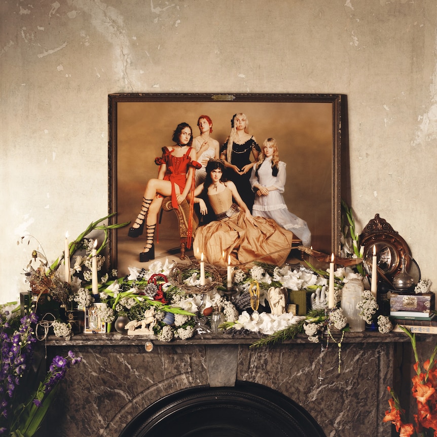 Image of a photograph of the The Last Dinner Party placed on top of the fire place.