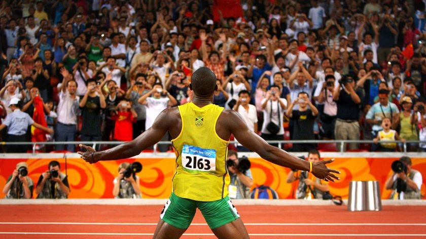 Ejoying his job: Jamaica's Usain Bolt celebrates at the Bird's Nest.