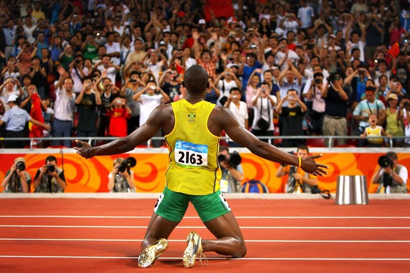 Usain Bolt celebrates with the crowd at the Bird's Nest stadium after winning the men's 200m final