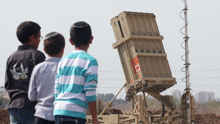 Israeli children look at the Israeli military's Iron Dome defence missile system, designed to intercept incoming rockets.
