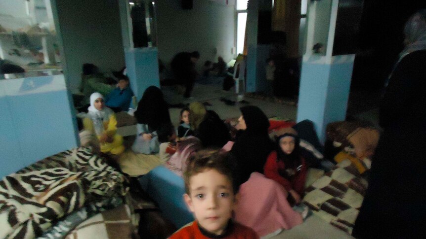 Residents take refuge in a shelter in the Sunni Muslim district of Bab Amro in Homs, Syria