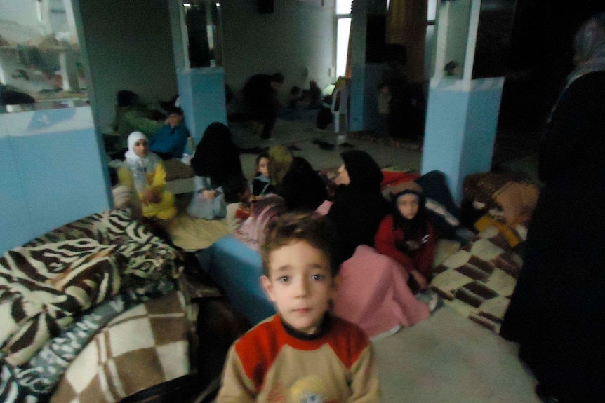 Residents take refuge in a shelter in the Sunni Muslim district of Bab Amro in Homs, Syria