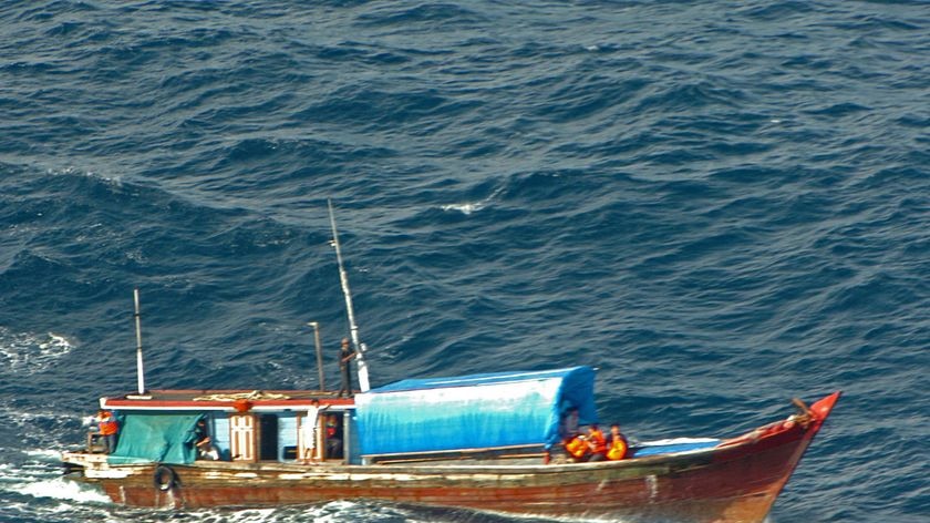A vessel carrying suspected asylum seekers sails on the high seas after being intercepted