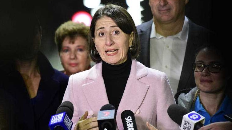 Gladys Berejiklian in a pink coat speaking to media.