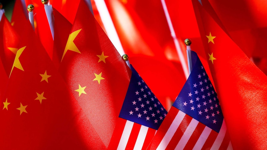 American flags are displayed together with Chinese flags on top of a trishaw in Beijing.