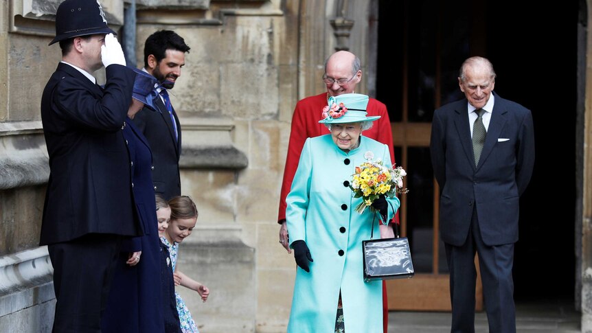 Girls curtsey as Britain's Queen Elizabeth and prince Philip leave the Easter Sunday service in Windsor Castle.