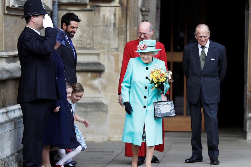 Girls curtsey as Britain's Queen Elizabeth and prince Philip leave the Easter Sunday service in Windsor Castle.