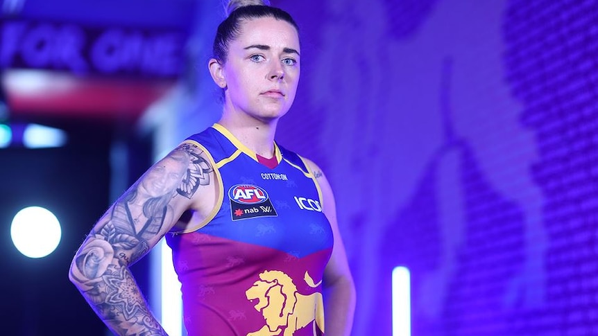 Brisbane Lions player Jessica Wuetschner stands in her uniform looking at the camera.