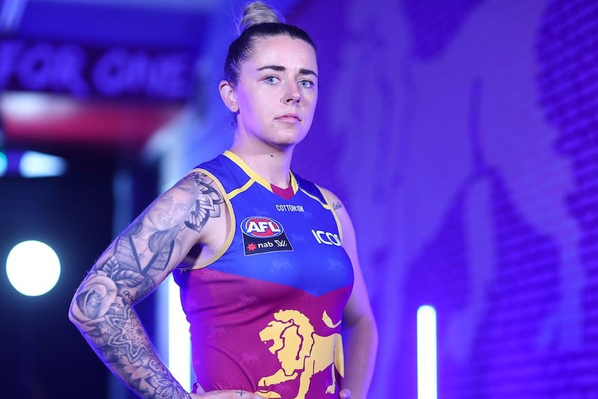 Brisbane Lions player Jessica Wuetschner stands in her uniform looking at the camera.