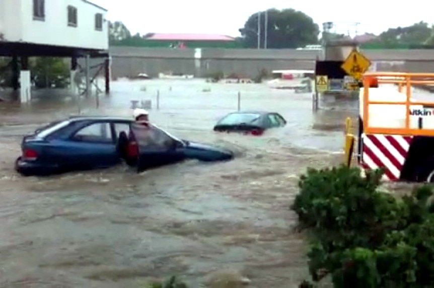 A flooded car park at a large shopping centre.