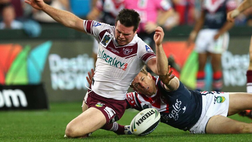 Jamie Lyon tackled by Mitchell Aubusson