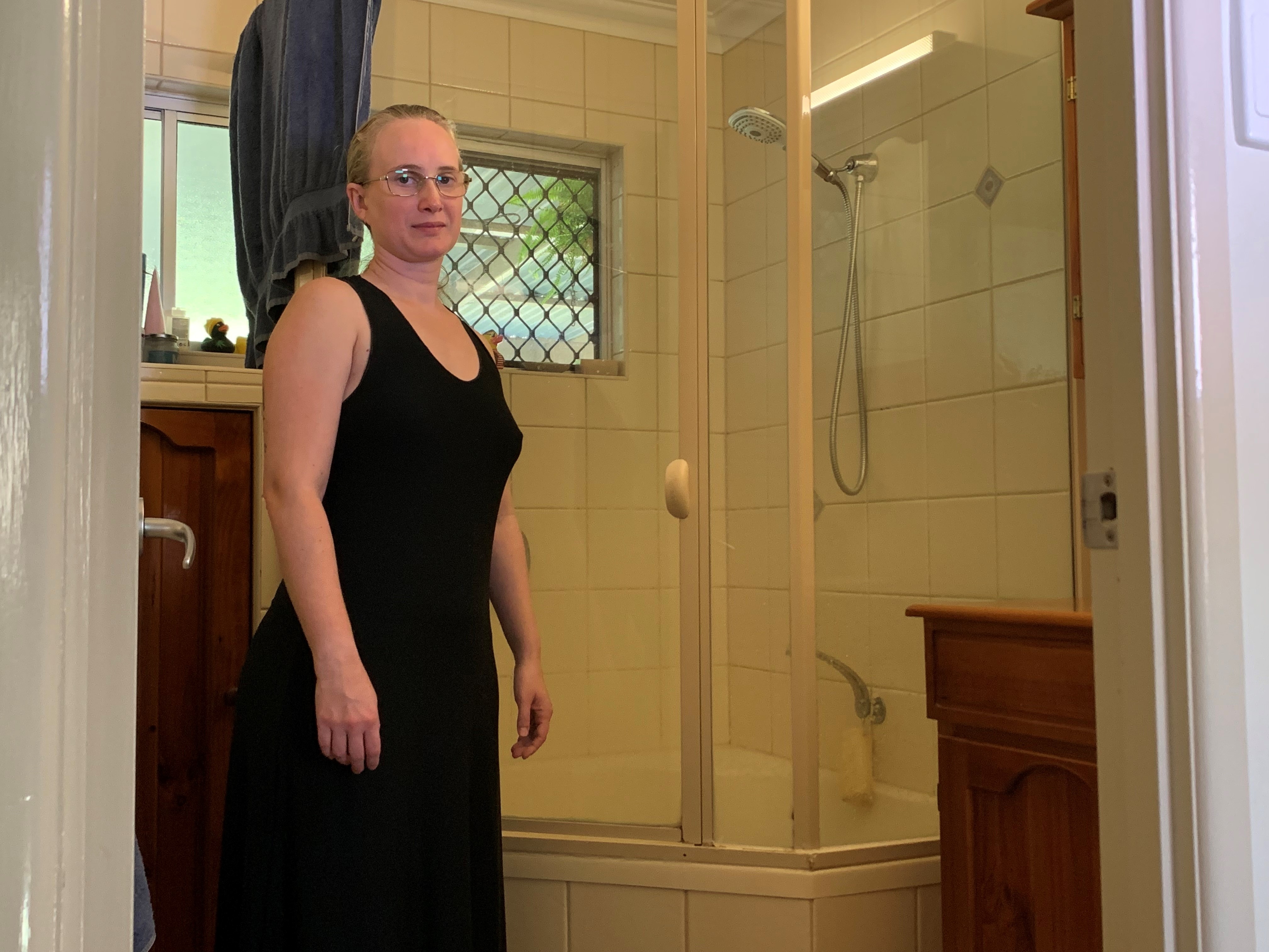 a woman in a bathroom with a tub and toilet