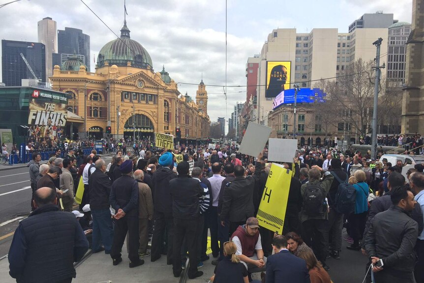 Protesters in Flinders Street rally against taxi changes