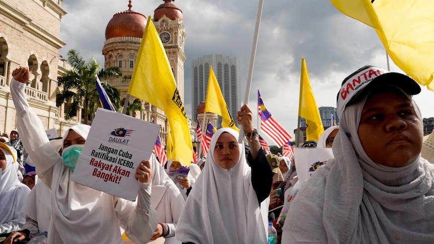 Thousands of protesters march through the streets wearing white