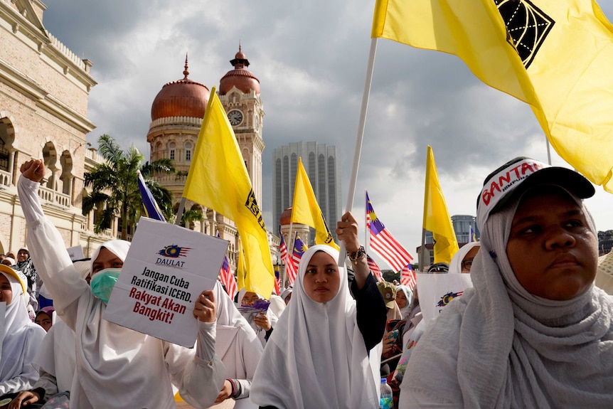 Thousands of protesters march through the streets wearing white