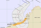 A map shows the cyclone's track expected to cross the coast.