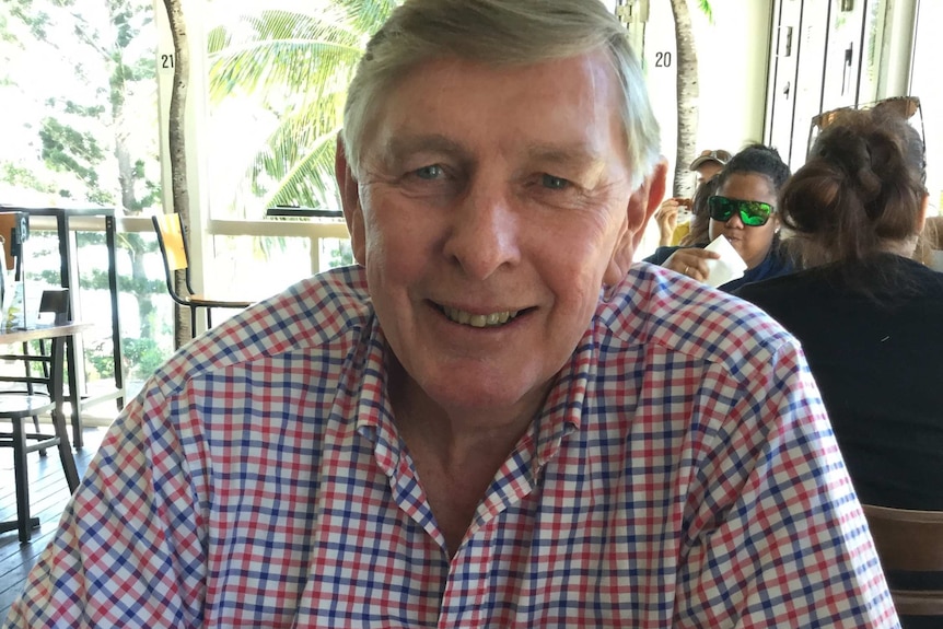 Carl Upton sitting at a table and smiling on an unspecified date.