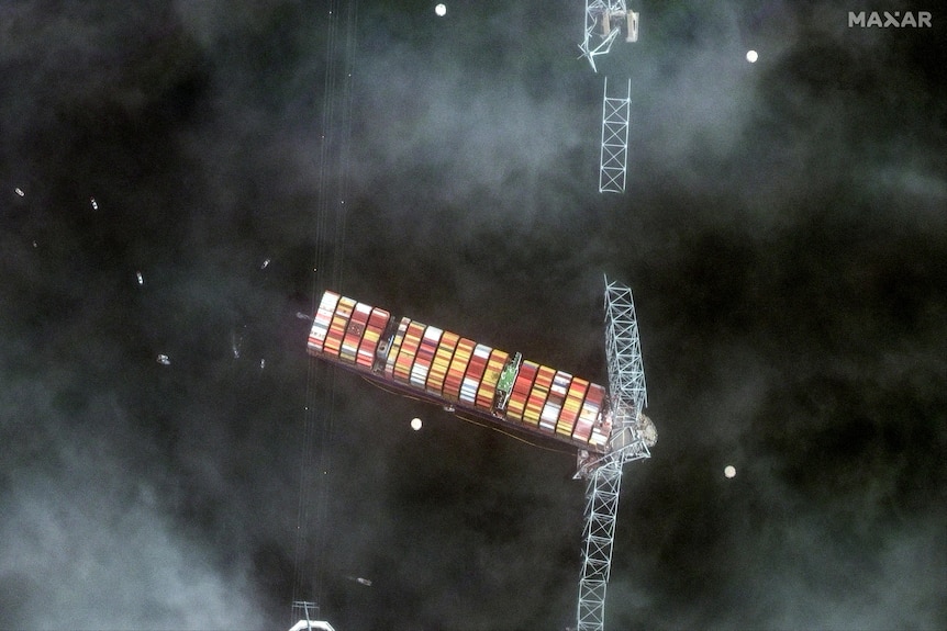 An overhead view of a cargo ship with a broken bridge on top
