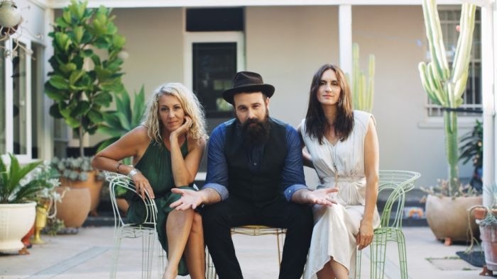 Donna Simpson, Josh Cunningham and Vikki Thorn sitting on seats in back garden