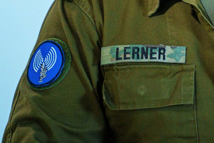 A close up image of a man's military unifom with a badge on it that reads LERNER in capital letters