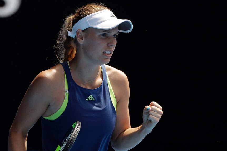 Caroline Wozniacki pumps her fist during her Australian Open semi-final against Elise Mertens.