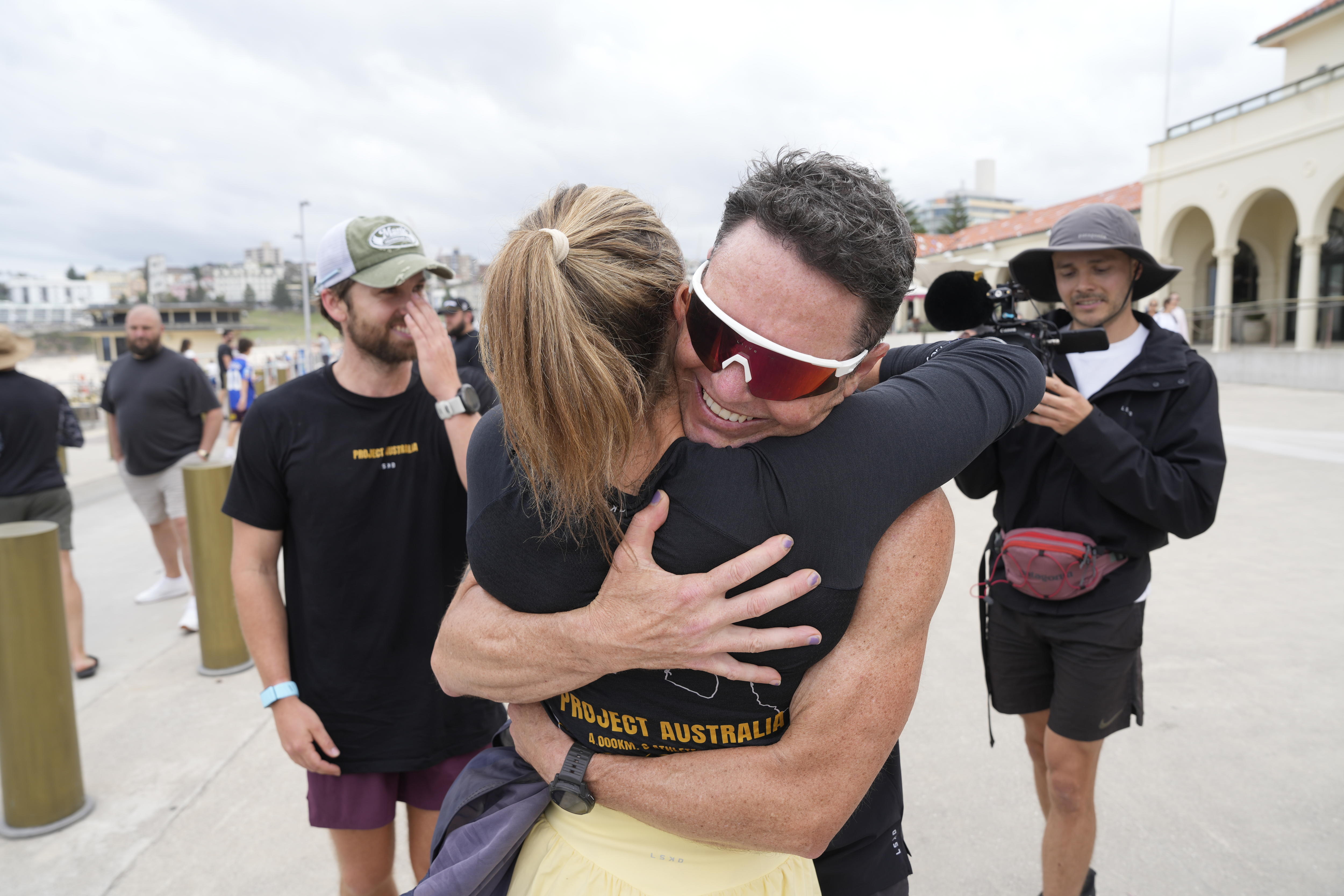 A man and a woman embrace.