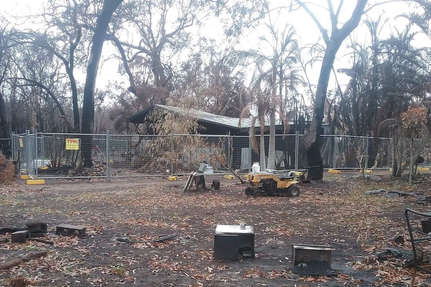 A burnt-out house in burnt bushland
