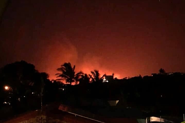 Red sky at night from bushfire flames as the fire approaches homes.