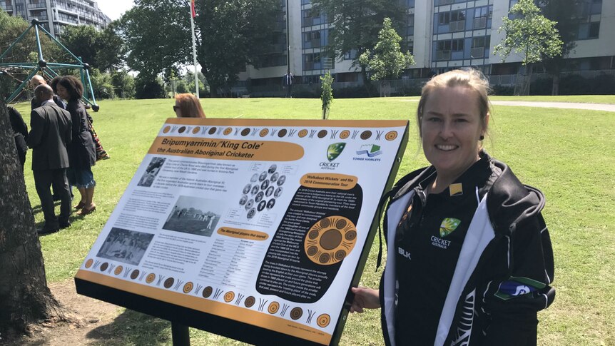 Sally Moylan stands beside the noticeboard in Victoria Park, UK.