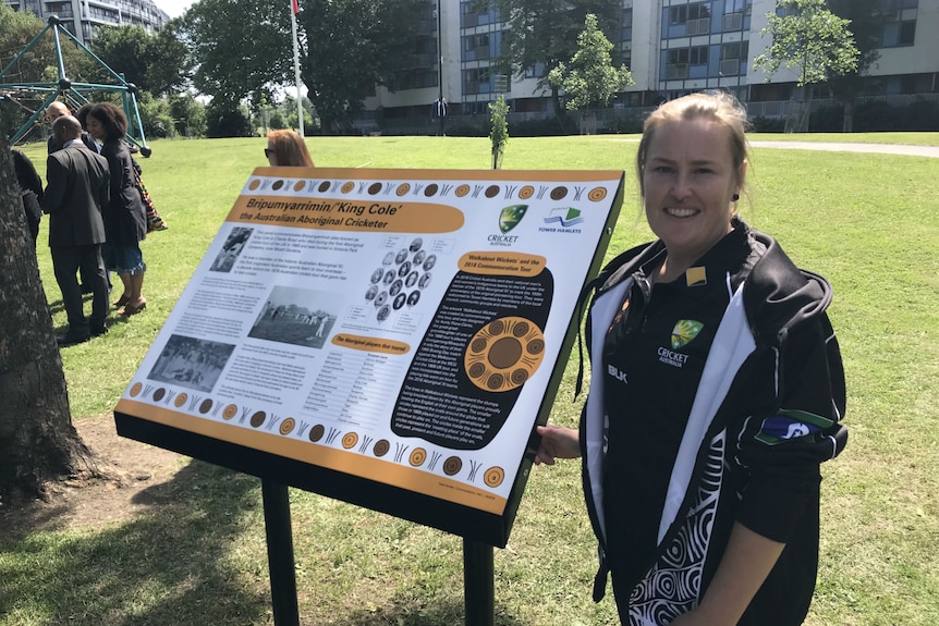 Sally Moylan stands beside the noticeboard in Victoria Park, UK.