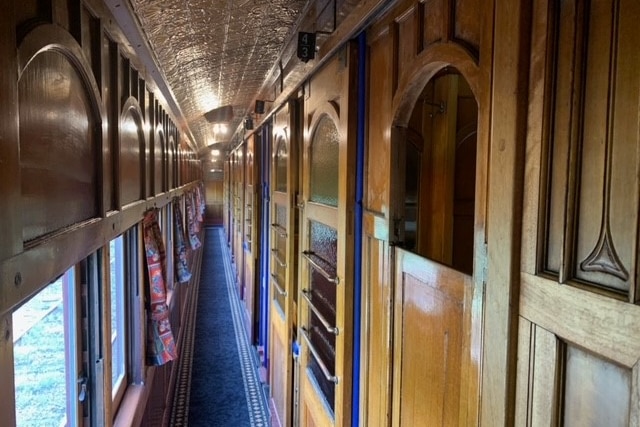 the hallway of an old wooden bodied train carriage