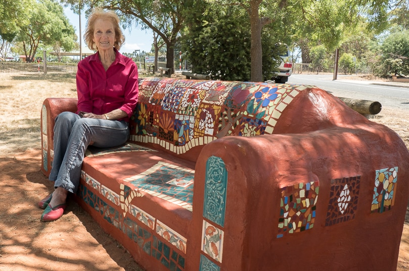 Joan Playford sits on Kersbrook community mosaic couch.