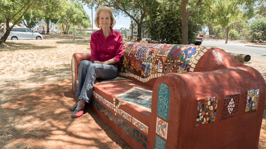 Joan Playford sits on Kersbrook community mosaic couch.