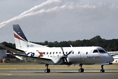 A small aircraft branded 'Rex' travels down a runway.