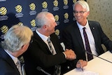 Graham Arnold shakes hands with David Gallop